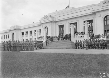 Armistice Day Ceremony with the Royal Military College Cadets on parade in front of Parliament House. Boy Scouts on the right. View from Parkes Place.