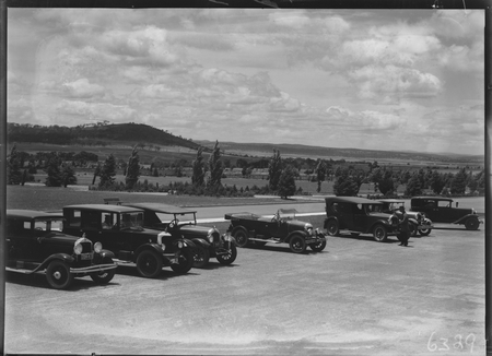 Motor cars outside Parliament House. Mt. Pleasant in background.