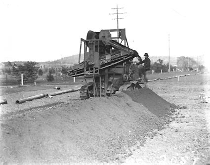 Barber Green ditch digger digging a trench for a water pipeline in Reid area