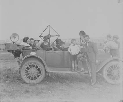 Martin family in their Studebaker with radio, radio aerial and cameraman Bert Martin