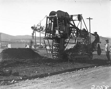 Barber Green ditch digger digging a trench for a water pipeline in Reid area