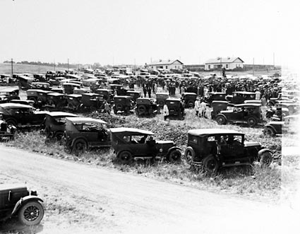 Part of vehicles and crowds at Foundation Stone ceremony of the Roman Catholic Convent , Manuka