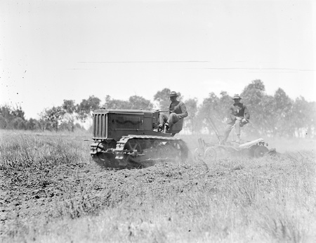 Crawler tractor pulling a tandem disc plough.