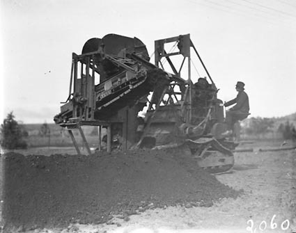Barber Green ditch digger digging a trench for a water pipeline in Reid area