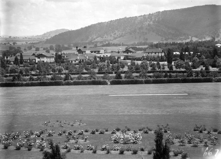Gardens and Hotel Canberra from Parliament House with Black Mountain behind.