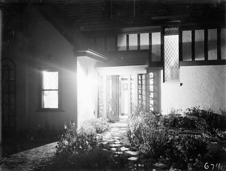 The house of George H. Romans, Mugga Way, Red Hill. Romans was Chief Hansard Officer, Parliament House. Front entrance at night.