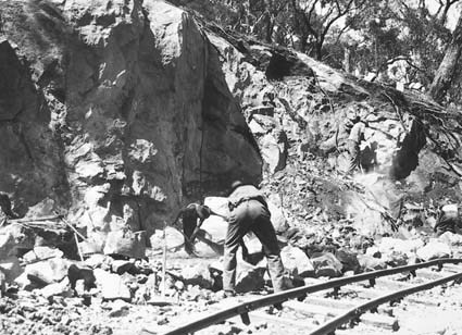 Quarry men at work on the rock face