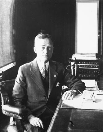 Hon TW White, Minister for Trade and Customs, in his office