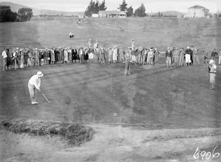 Canberra Golf Course. A golfer putting on the final green before spectators.