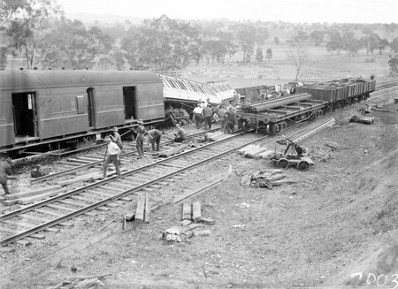 Derailment of the Albury Mail Train at Bowning at 4.30 AM. Train was travelling at 35 MPH and 6 carriages were derailed. 6 passengers were injured. Rescue waggons beside the derailed carriages.