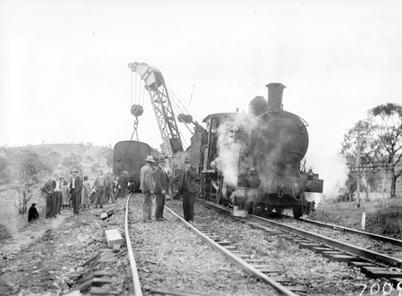 Derailment of the Albury Mail Train at Bowning at 4.30 AM. Train was travelling at 35 MPH and 6 carriages were derailed. 6 passengers were injured. Engine and crane lifting a carriage back on the line.