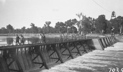 Murray River Commission.Men walking across a weir on the Murray River
