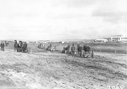 Cletrac crawler tractors and horses teams pulling scrapers for landscaping near Parliament House
