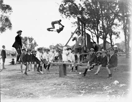 Children on a see-saw and swing at a school sports day, Acton Sports Ground.