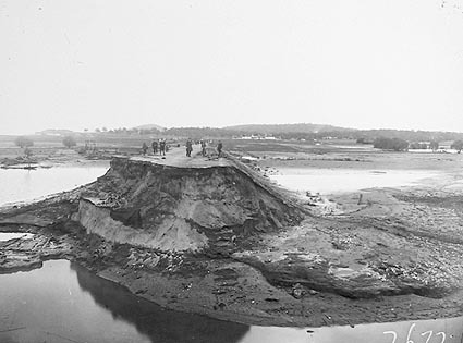 Looking south from Commonwealth Bridge showing flood damage to approaches and the washed away abutment