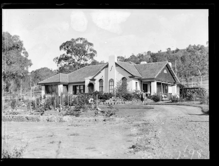 John Dean's House, 18 Mugga Way. Mrs Dean in the garden.