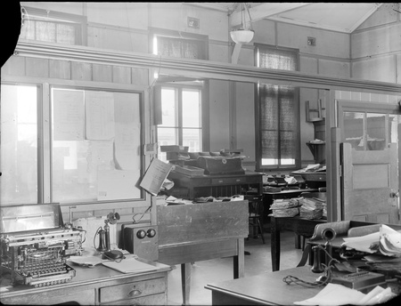 Interior of Acton office - Note Remington teleprinter, telephones and telephone directory on wall								