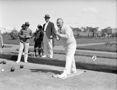 Bowlers on the bowling green at the Hotel Canberra. Mr H. R. Waterman bowling.