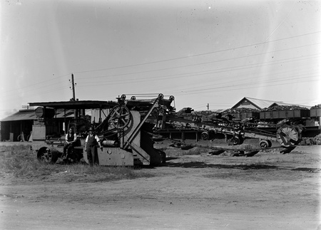 Parsons mechanical excavator and railway trucks loaded with coal.