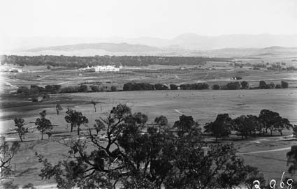 View of Parliament House and East Block from Russell Hill showing farm buildings near river