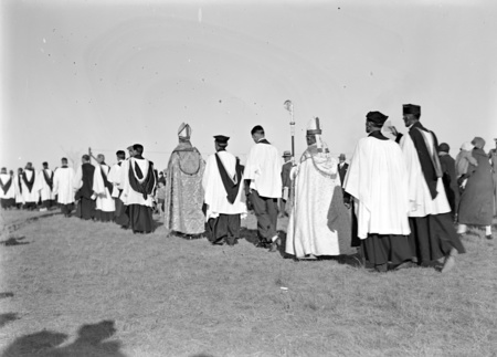 Royal Visit, May 1927. Procession of clergy at the dedication ceremony for the site of St Marks Anglican Cathedral on Rottenbury Hill.
