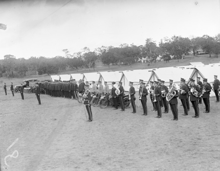 Royal Visit, May 1927. Band and police officers on parade outside tents with their motorcycles.