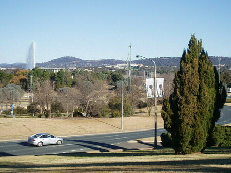 From City Hill with the Captain Cook fountain to the left, New Parliament House in the middle and Commonwealth Avenue running down the right